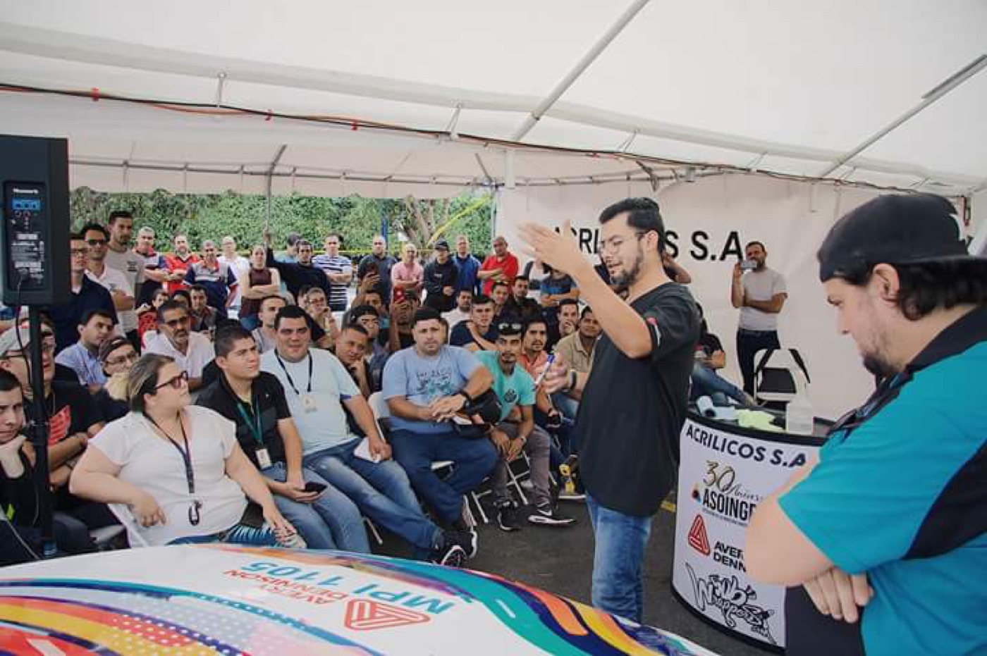 Live vehicle wrap demonstration at a graphics industry event